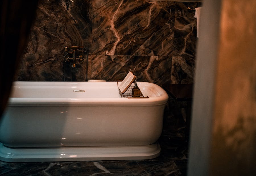 Moody marble bathroom with freestanding tub