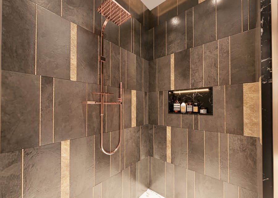 Dark stone walk-in shower with copper fixtures