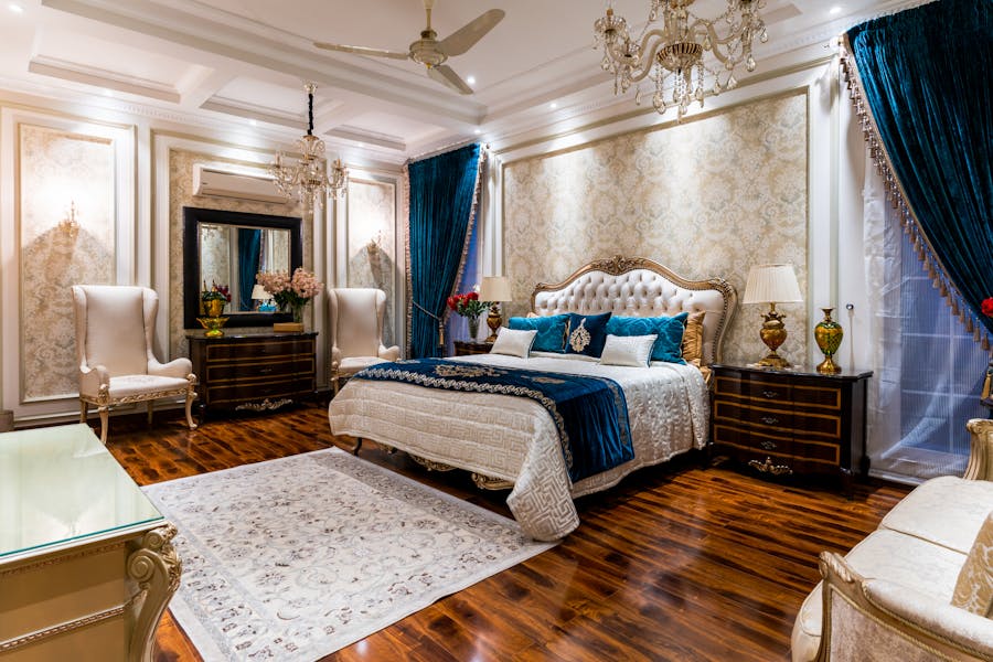 Classic luxury master bedroom with chandelier and velvet curtains