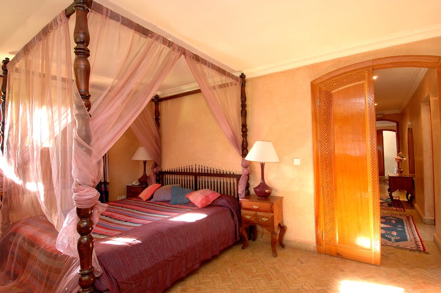 Four-poster canopy bedroom with romantic lighting