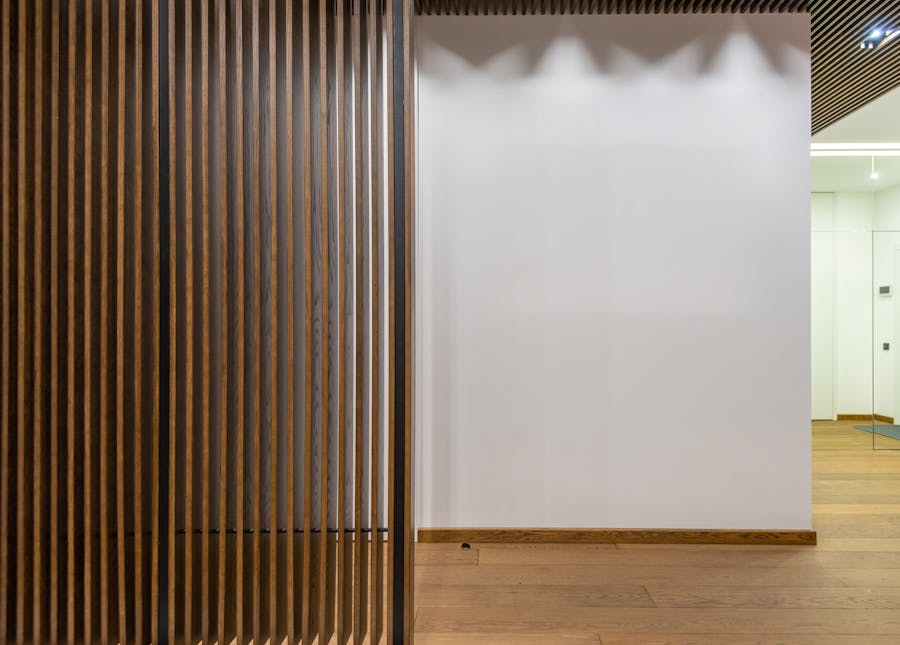 Modern slat wood partition with warm light filtering